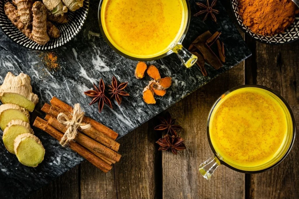 Golden Milk with Raw Ingredients Displayed