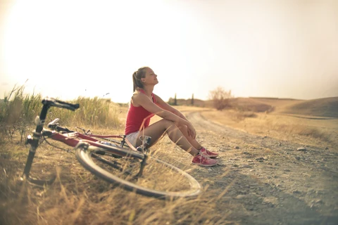 Microdosing cannabis edibles: Girl on bike at sunrise